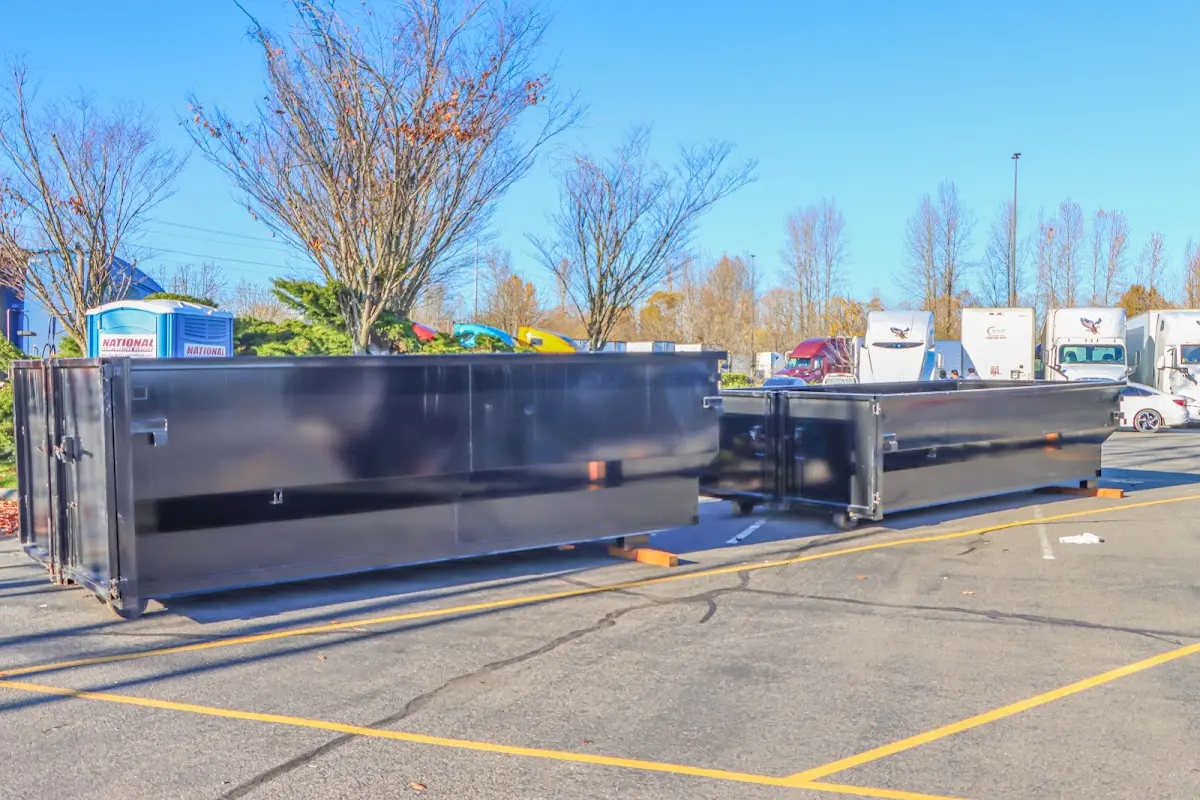 Professional dumpster rental service with roll-off container on residential driveway in Maumelle